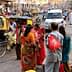 People interacting on a busy street in India with various vehicles and pedestrians present. - Olive Oil Times