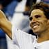 Tennis player Rafael Nadal smiling and raising his hand in celebration at a match. - Olive Oil Times