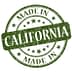 Green circular stamp with the text 'Made in California' and stars in a distressed style. - Olive Oil Times