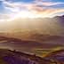 Panoramic view of the Basilicata region in Italy with mountains and valleys under a sunset sky. - Olive Oil Times