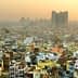 Aerial view of densely populated urban area in Delhi with buildings and rooftops visible. - Olive Oil Times