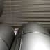 Stacked metal storage tanks in a warehouse with a metallic finish and cylindrical shape. - Olive Oil Times