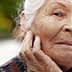 Elderly woman with gray hair and a thoughtful expression, resting her chin on her hand. - Olive Oil Times