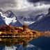Mountain landscape featuring peaks and a lake reflecting the scenery in Torres del Paine National Park. - Olive Oil Times
