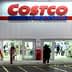 Exterior view of a Costco Wholesale store with customers entering and exiting. - Olive Oil Times
