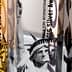 Three awards featuring the Statue of Liberty design with gold and silver text indicating the year and award type. - Olive Oil Times