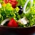 Bowl of fresh garden salad containing lettuce, tomatoes, olives, and onions. - Olive Oil Times
