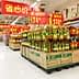 Rows of cooking oil bottles arranged on pallets in a supermarket aisle. - Olive Oil Times