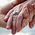 Close-up of two hands holding each other, one adorned with a silver ring. - Olive Oil Times