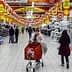 View of a supermarket aisle with shoppers and various products displayed on shelves. - Olive Oil Times