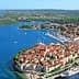 Aerial view of Korčula Island featuring the town and surrounding sea with boats. - Olive Oil Times