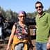 Two individuals posing for a photo in an olive grove during the olive harvesting process. - Olive Oil Times
