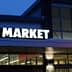 Exterior view of an ALDI food market with illuminated signage at dusk. - Olive Oil Times