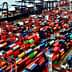 Aerial view of a container ship docked at a port surrounded by colorful shipping containers. - Olive Oil Times
