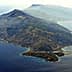 Aerial view of Ikaria Island showing mountainous terrain and coastal features. - Olive Oil Times
