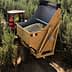 Tractor with a large trailer collecting olives in an olive grove. - Olive Oil Times
