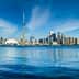 Panoramic view of Toronto skyline featuring the CN Tower and waterfront. - Olive Oil Times