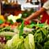 Variety of fresh vegetables including lettuce and radicchio displayed at a market stall. - Olive Oil Times