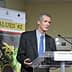 Francesco Visioli speaking at the International Conference on Food Values with a presentation backdrop. - Olive Oil Times