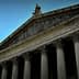 Facade of a New York City courthouse featuring tall columns and sculptures on the roof. - Olive Oil Times