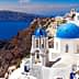 View of Santorini island featuring white buildings with blue domes against the sea. - Olive Oil Times