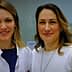 Two women smiling in a laboratory environment, one wearing a lab coat and the other in a white sweater. - Olive Oil Times