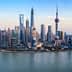 Panoramic view of the Shanghai skyline featuring modern skyscrapers and the Huangpu River. - Olive Oil Times