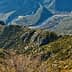 Aerial view of a mountainous landscape featuring a curving river and rocky terrain. - Olive Oil Times