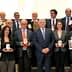 Group photo of winners holding awards at the 26th Ercole Olivario event. - Olive Oil Times