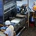 Workers operating food processing machinery in a factory setting with various equipment. - Olive Oil Times