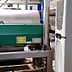 Industrial machinery used for olive oil processing, featuring a green motor and stainless steel tanks. - Olive Oil Times