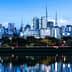 Cityscape of Sao Paulo featuring skyscrapers and reflections in water during dusk. - Olive Oil Times