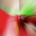 An abstract image featuring a colorful blur of red, green, and other colors radiating from a central point. - Olive Oil Times