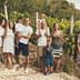 Group of people posing together in a vineyard with grapevines in the background. - Olive Oil Times