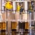 Industrial olive oil bottling machine with filled bottles on a production line. - Olive Oil Times