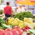 Assorted fresh vegetables including tomatoes, peppers, and cucumbers displayed at a market stall. - Olive Oil Times