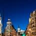 Night view of a cityscape in Madrid featuring illuminated buildings and streetlights. - Olive Oil Times