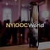A crystal trophy with the inscription 'NYIOOC World' prominently displayed in a blurred background. - Olive Oil Times