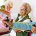 Four senior women using resistance bands for exercise in a seated position. - Olive Oil Times