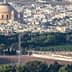 Aerial view of a city featuring a large dome structure and surrounding buildings. - Olive Oil Times