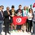 Group photo of Sfax Marathon winners holding a trophy and a Tunisian flag with event organizers. - Olive Oil Times