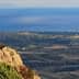Panoramic view of the coastline and distant island from a rocky outcrop. - Olive Oil Times