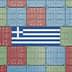 Shipping containers arranged in a pattern with the Greek flag in the center. - Olive Oil Times