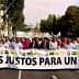 Group of people marching in a protest holding a large banner that reads 'Precios Justos Para Un Olivar'. - Olive Oil Times