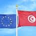 Flags of the European Union and Tunisia waving against a blue sky. - Olive Oil Times