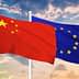 Chinese flag on the left and European Union flag on the right, both waving against a cloudy sky. - Olive Oil Times
