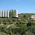 Cruzcampo brewery facility with silos and a large sign in a rural landscape. - Olive Oil Times