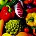 A variety of colorful vegetables and fruits including peppers, carrots, and broccoli. - Olive Oil Times