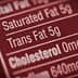 Close-up of a nutrition label indicating 5g of trans fat content. - Olive Oil Times