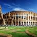 The Colosseum in Rome, an ancient amphitheater with arches and a partially intact structure. - Olive Oil Times